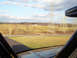 1992 Ford Bronco - View from inside a vehicle looking out at a rural landscape with power lines under a cloudy sky.