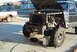 1986 Ford Bronco - Ford Bronco front end undergoing modification, with a second truck visible in the background.