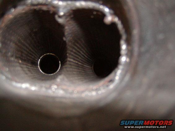 Close-up of dual exhaust pipes with visible internal rifling