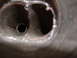 1991 Ford Bronco - A close-up view shows the interior of dual exhaust pipes, revealing their internal construction.