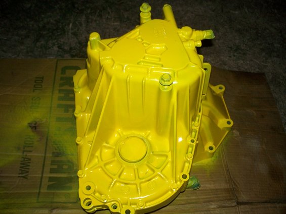 Yellow transmission part on a cardboard box with 'KRAFT' visible