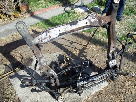 Subframe assembly with steering rack and suspension components removed from a vehicle