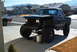 1986 Ford Bronco - This heavily modified Ford Bronco features a lifted suspension and oversized tires, parked outside a suburban home.