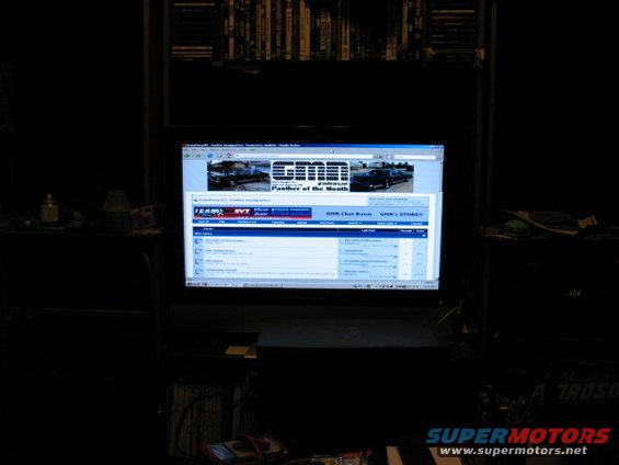 Computer screen displays a car forum with two cars in the banner image