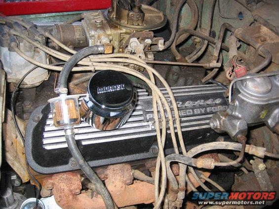 Engine bay of a 1968 Ford Bronco, showing the V8 engine with a Moroso oil cap and a fuel filter