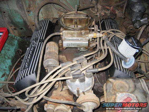 Engine bay with black valve covers reading "Bronco" in silver lettering