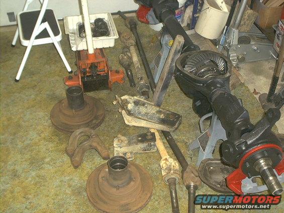 Axle components and orange jack on floor