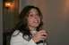1966 Ford Bronco - A woman with brown hair smiles while holding a glass of wine at a party.