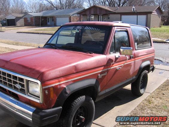 Red 1984 Ford Bronco II with V6 badge and 'Bronco II' lettering