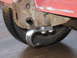1984 Ford Bronco II - A close-up view of a chrome tow hook attached to the frame of a vehicle, with a tire visible in the background.