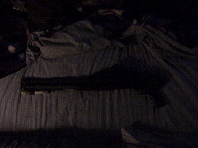 Gun lying on a dark, textured surface