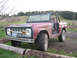1968 Ford Bronco - This 1968 Ford Bronco is shown in a rural setting with a dirt road and grassy hills in the background.