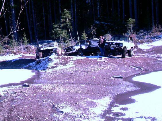 1987 Ford Bronco II parked in snow with two other off-road vehicles