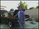 1965 Ford Mustang - A man stands next to a brown 1967 Ford Mustang coupe with both the hood and trunk open.