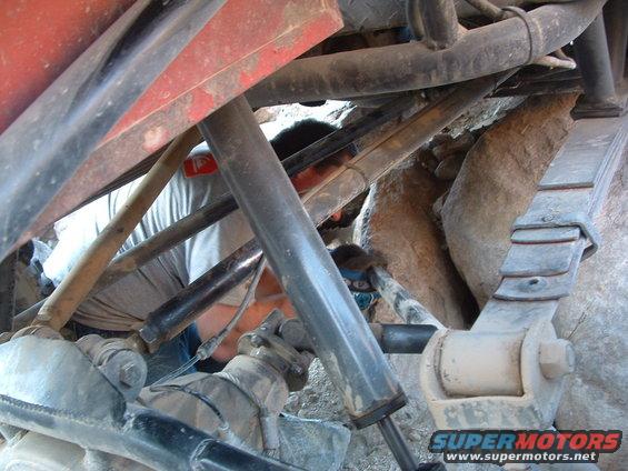 Close-up of leaf springs and shocks on a vehicle's undercarriage