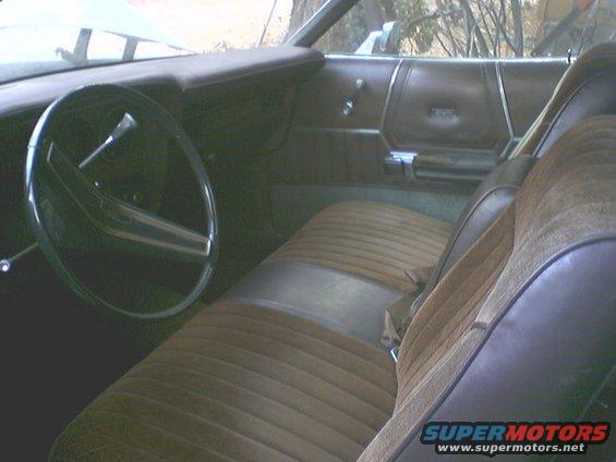 Brown velour interior of a 1973 Ford Ranchero with a two-spoke steering wheel