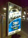 1999 Mercury Grand Marquis - A billboard displays a 2007 Ford vehicle with Arabic text below.