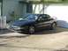 1994 Ford Probe - Black 1994 Ford Probe coupe parked on a concrete driveway next to a garage.