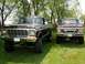 1979 Ford F-250 - Two Ford trucks, a lifted black F-250 and a brown F-250, are parked side-by-side on a grassy lawn.