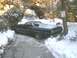 1973 Ford Ranchero - A black 1973 Ford Ranchero is parked on a snow-covered driveway, with snow chains on its rear tires.
