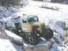 1978 Ford Bronco - This heavily modified truck navigates a snowy, rocky terrain with its exposed engine and large off-road tires.