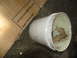 1978 Ford Bronco - A cardboard box and a bucket are on a concrete floor, with text visible on the box.
