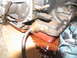1978 Ford Bronco - A close-up view of a leaking transmission pan with a red gasket and fluid spill.