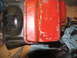 1978 Ford Bronco - A close-up view of a transmission oil pan, showing its red painted surface and bolted connection to the transmission housing.