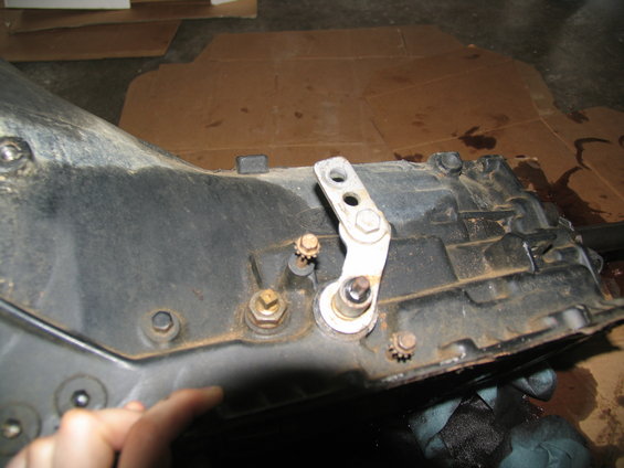 Transmission housing with a metal linkage and bolts