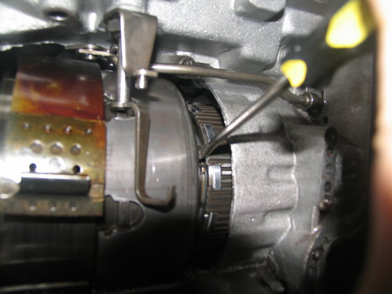 Transmission clutch pack and gears being worked on with a tool