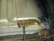1996 Ford Bronco - Close-up of a rusted metal floor section being repaired with rivets and a chisel.