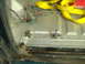 1996 Ford Bronco - Interior floor of a vehicle undergoing rust repair, with exposed wiring and a yellow strap.