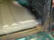 1996 Ford Bronco - Close-up view of a vehicle's interior floor showing rust treatment and protective coating application.