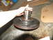 1978 Ford Bronco - Transmission pump part being held by a hand, likely during a repair or rebuild.