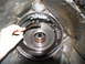 1978 Ford Bronco - A hand removes a clutch pack from a transmission housing, revealing internal components.