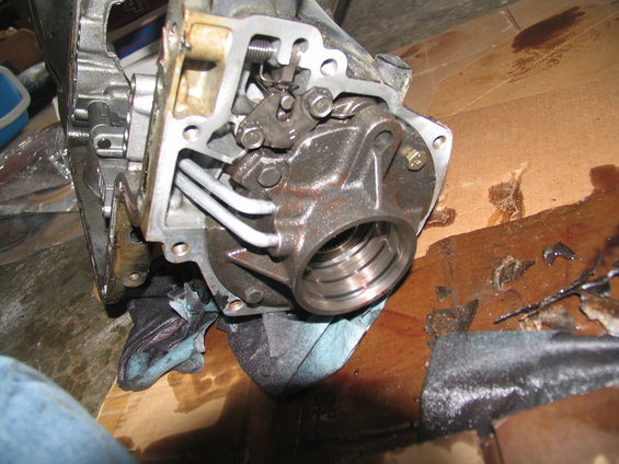 Close-up of a disassembled transmission component with internal gears and linkages visible