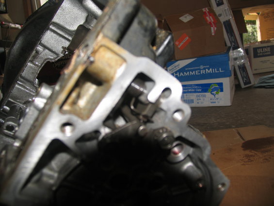 Close-up of a metal transmission component with internal gears and levers visible