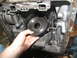 1978 Ford Bronco - Close-up of a transmission component being removed from its housing.