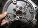 1978 Ford Bronco - A hand holds a metal transmission part, revealing internal components and bolt patterns.