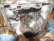 1978 Ford Bronco - A person is holding a disassembled transmission drum, revealing internal gears and casing components.