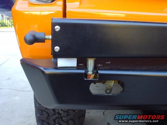 Close-up of an aftermarket rear bumper with a black finish and a spare tire mount mechanism