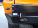 1977 Ford Bronco - Aftermarket rear bumper detail, showing mounting hardware and tire carrier attachment point.