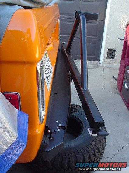 Orange 1977 Ford Bronco rear with external spare tire carrier and license plate