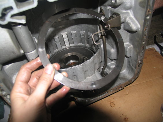 Hand holding metal ring inside transmission housing