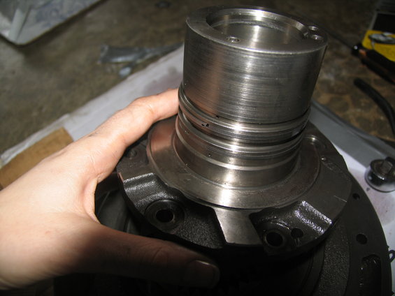 Hand holding a metal transmission component with machined grooves