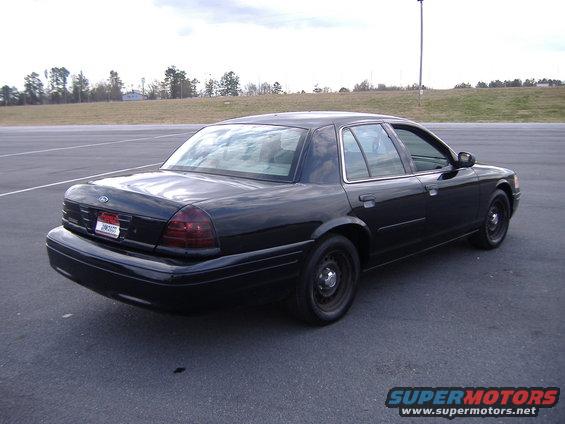 Black 2001 Ford Crown Victoria sedan, rear quarter view, parked on asphalt