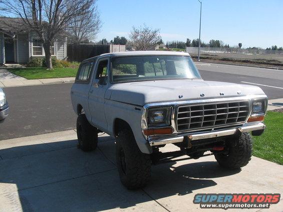 Gray 1978 Ford Bronco with lifted suspension and large tires parked on a driveway