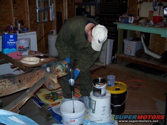 Spinning stirer in empty bucket to clean off extra paint