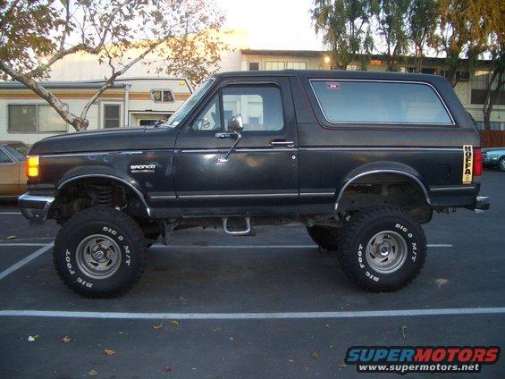 Black Ford Bronco lifted with off-road tires, parked in a lot