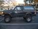 1988 Ford Bronco - This lifted Ford Bronco features off-road tires and a side profile view.